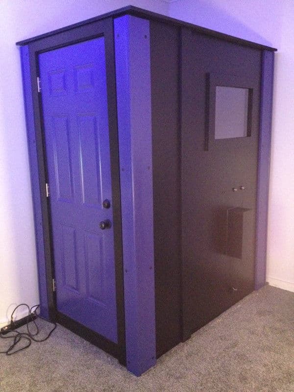 Unique enclosed booth with a purple door, modern design, and minimalistic features.