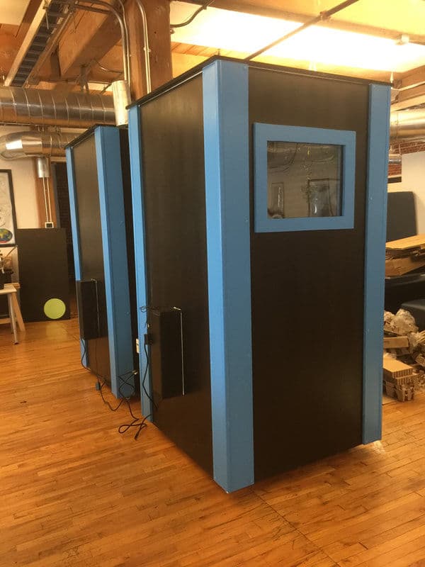 Modern soundproof booths for quiet workspace in a creative office setting.
