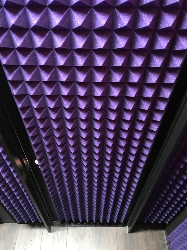 Purple acoustic foam wall panels in a modern design for soundproofing.
