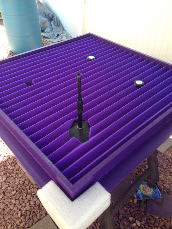 Purple foam water fountain base with adjustable nozzle, designed for outdoor use.
