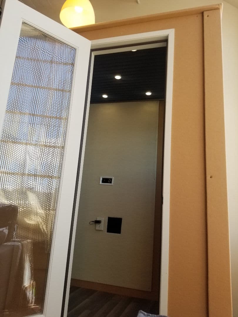 Interior view of a modern entrance with a textured glass door and sleek design elements.
